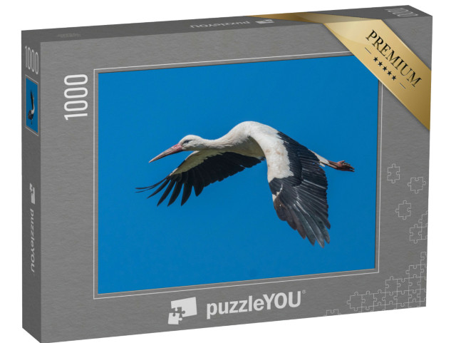 Puzzle 1000 Teile „Fliegender Weißstorch am blauen Himmel“