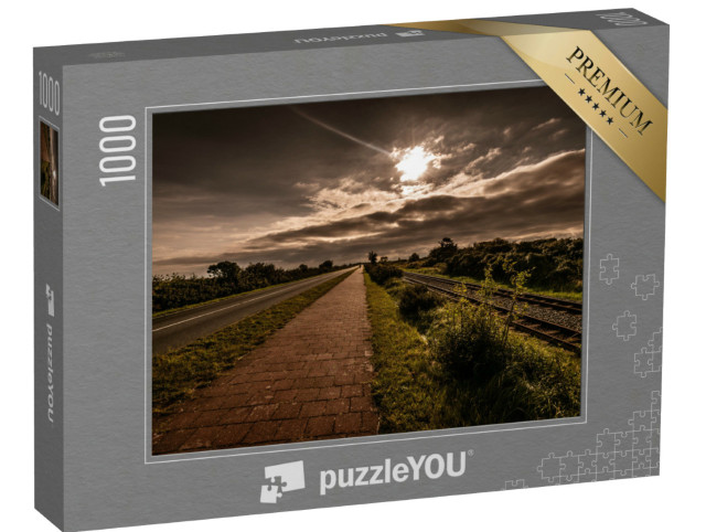 Puzzle 1000 Teile „Malerischer Blick auf Schienen und Straße in Borkum“