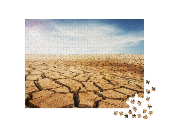 Puzzle 1000 Teile „Trockener und rissiger Wüstenboden, blauer Himmel mit Wolken“