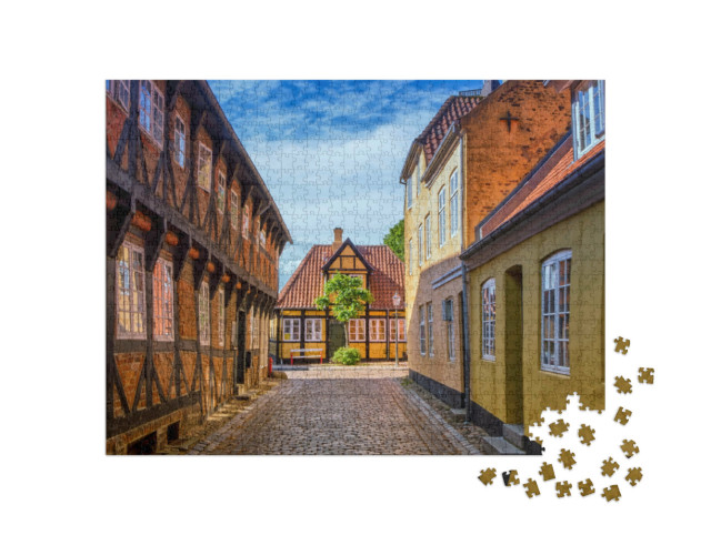Puzzle 1000 Teile „Straße und Häuser der mittelalterlichen Stadt Ribe in Dänemark“