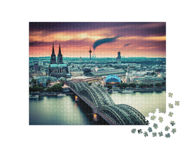 Puzzle 1000 Teile „Sonnenuntergang und bewegte Wolken über Köln, Deutschland“